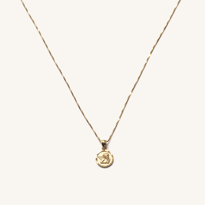 The 14k Cherub necklace, a solid gold cherub pendant on a dainty chain