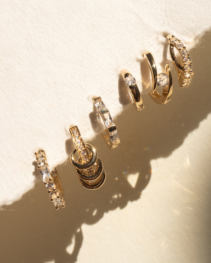 Multiple hoop earrings with stones on a fabric backing