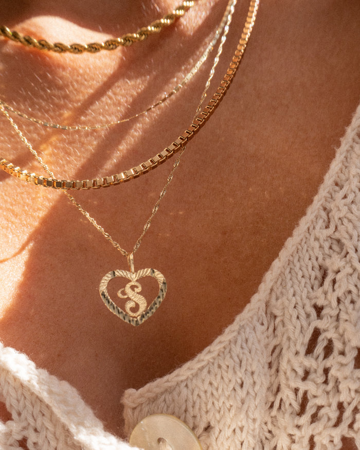Model wearing the 14k Corazon necklace with a personalized initial