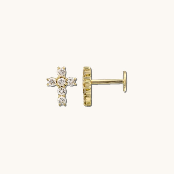 Close up of stone cross earrings on a white background