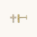 Close up of stone cross earrings on a white background