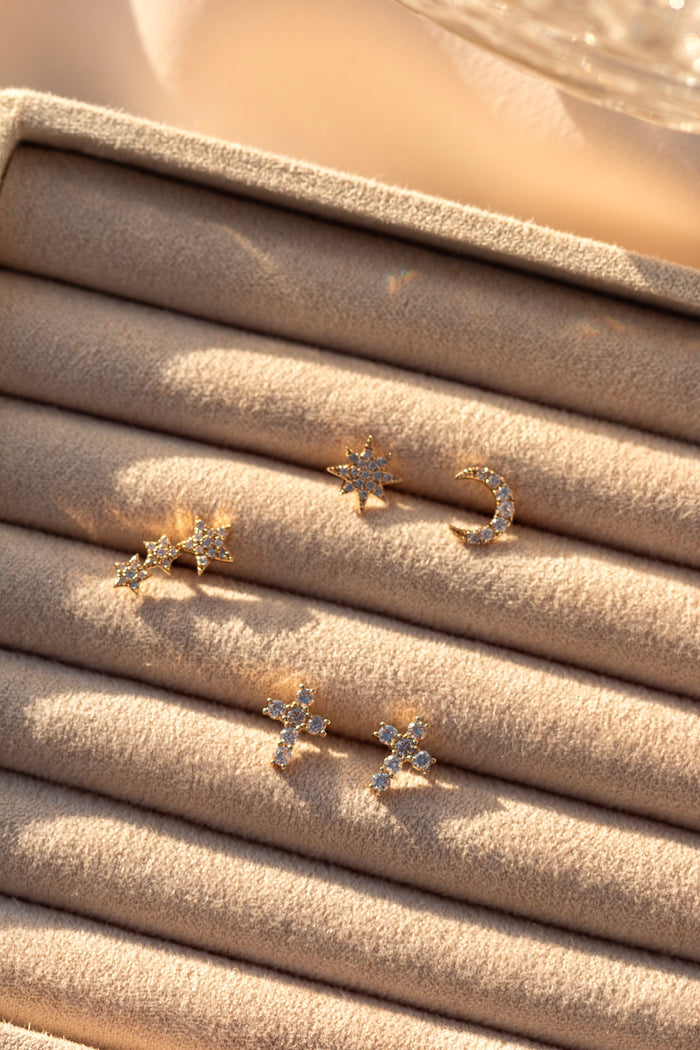Five stone stud earrings in a tan jewelry organizer