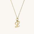 The Cursive initial necklace with a diamond-cut solid gold letter