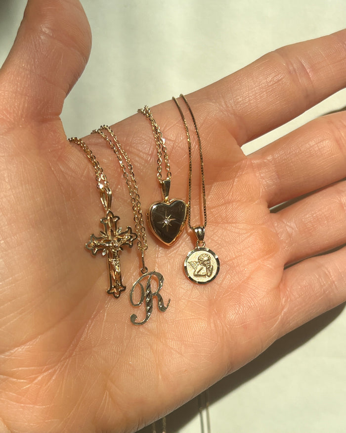 Model wearing the 14k Cursive initial necklace with a personalized letter