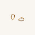 Close up of an ear wearing the 14k diamond Stella huggie earring