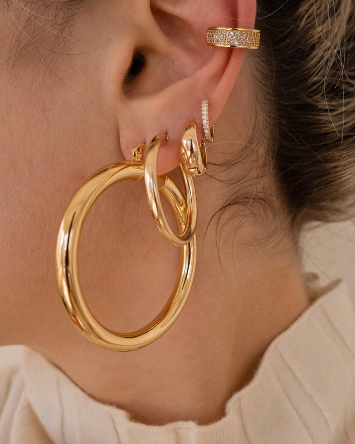 Fine 14k gold Stella huggie earring lined with genuine diamonds