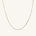Close up of the 14k gold Disco Tile chain necklace on a white background