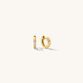Close up of gold hoops with stones on a white background