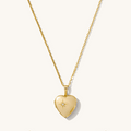The Love Locket necklace, a heart-shaped 14k gold locket with a CZ starburst