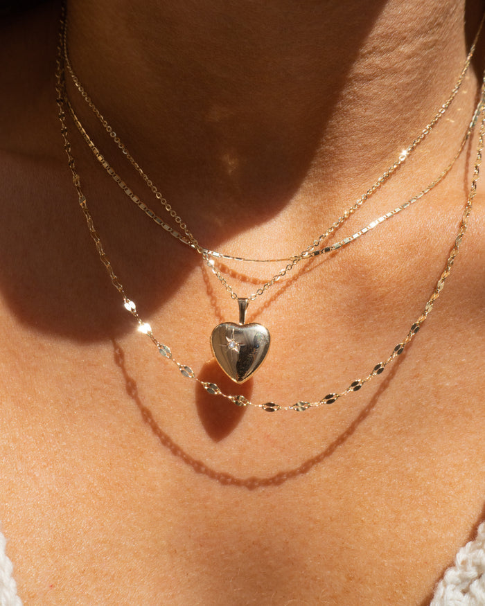 Model wearing the Love Locket heart pendant in 14k solid gold