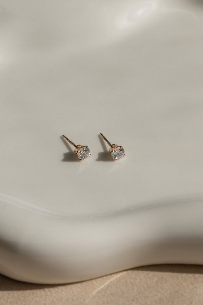 A pair of stone studs on a white platform