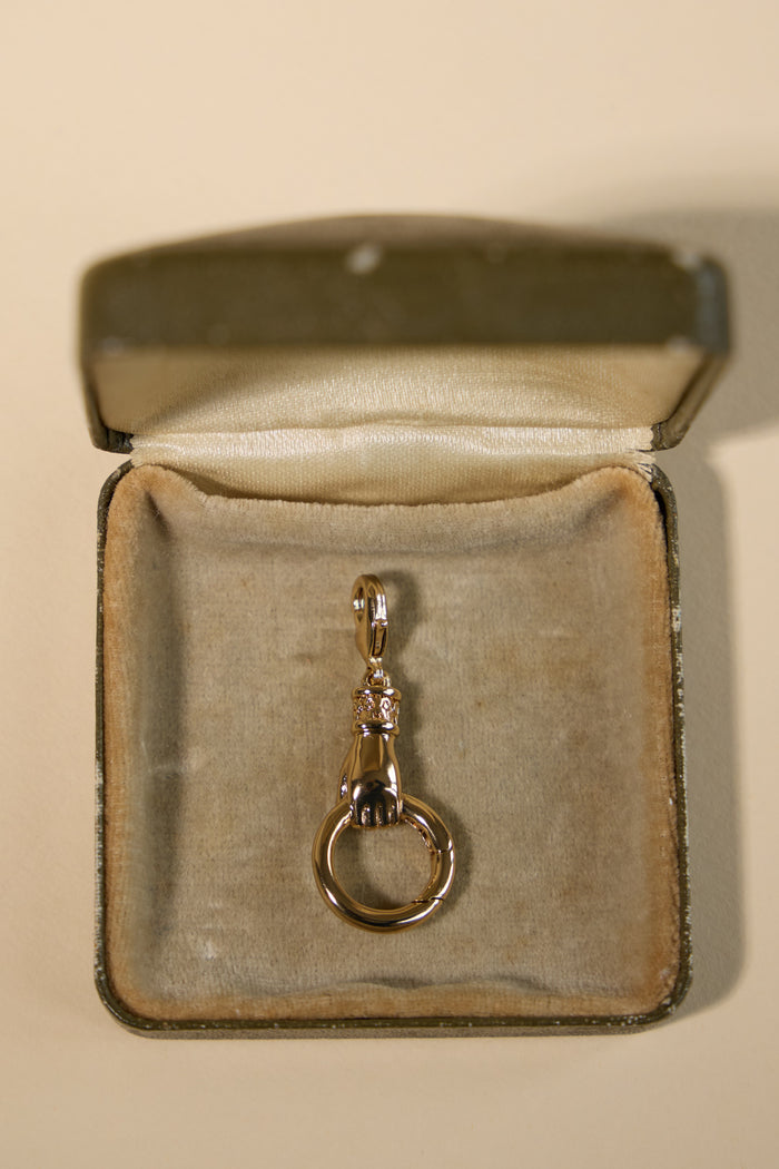 Model wearing the Curio charm connector as part of a layered stack
