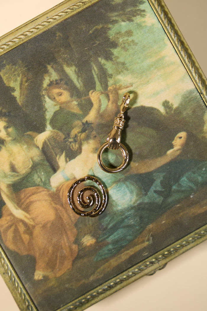 Model wearing a Beads by Tara charm connector on a layered necklace stack