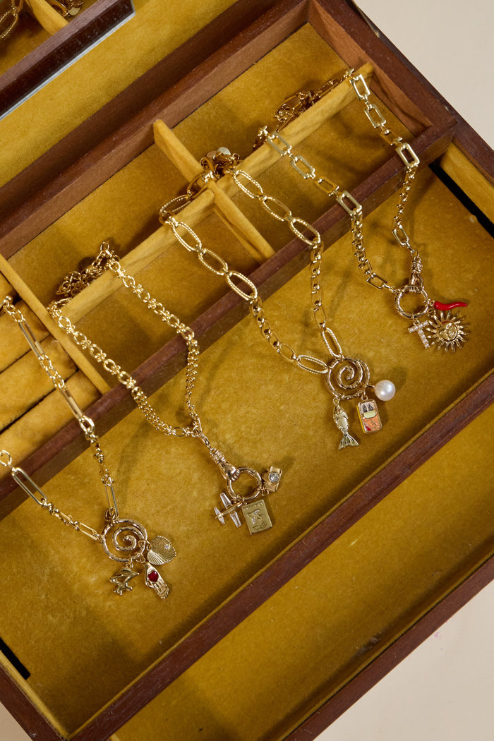 Model wearing the Curio connector holding a small cluster of charms