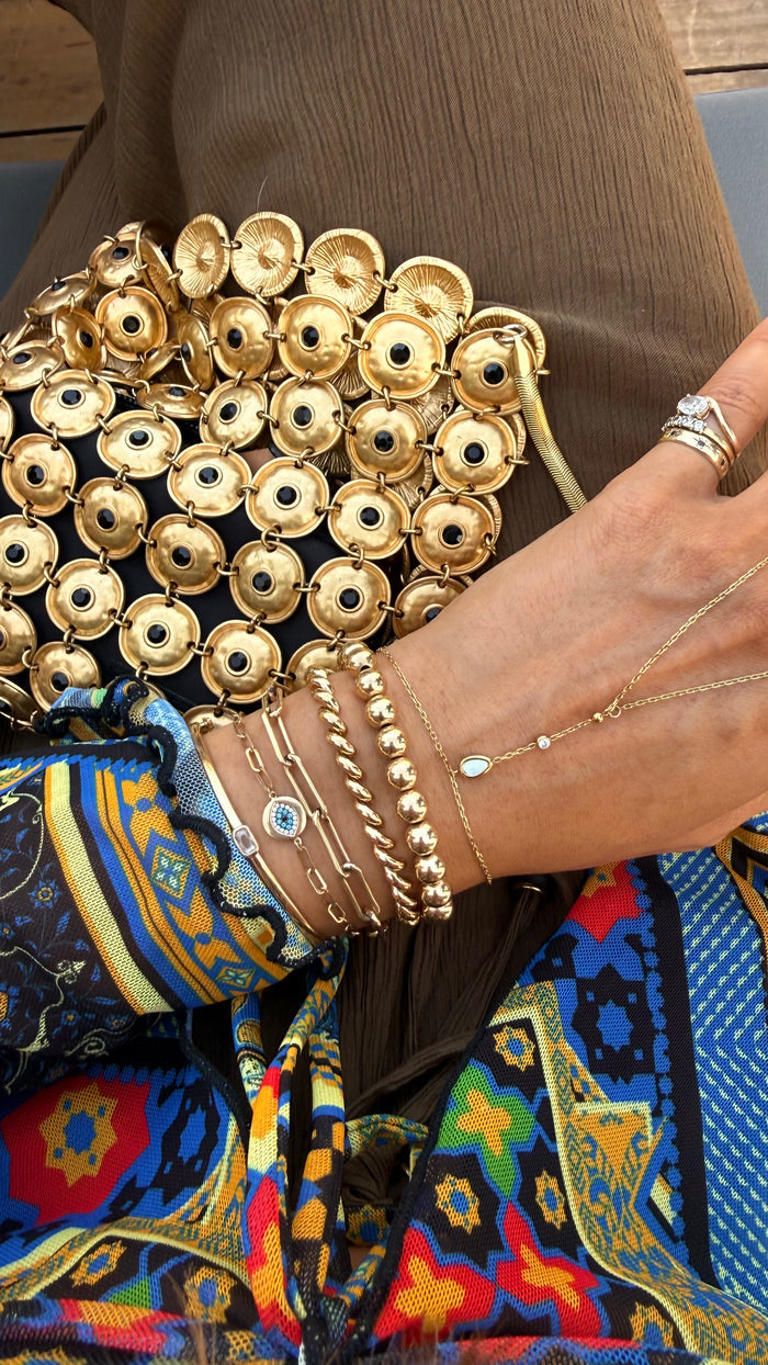 The Mother of Pearl hand chain, a barely-there 14k gold fill layering piece