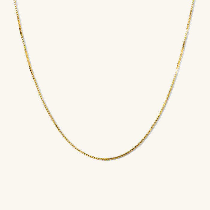 Close up of the gold Amanda layering chain necklace on a white background