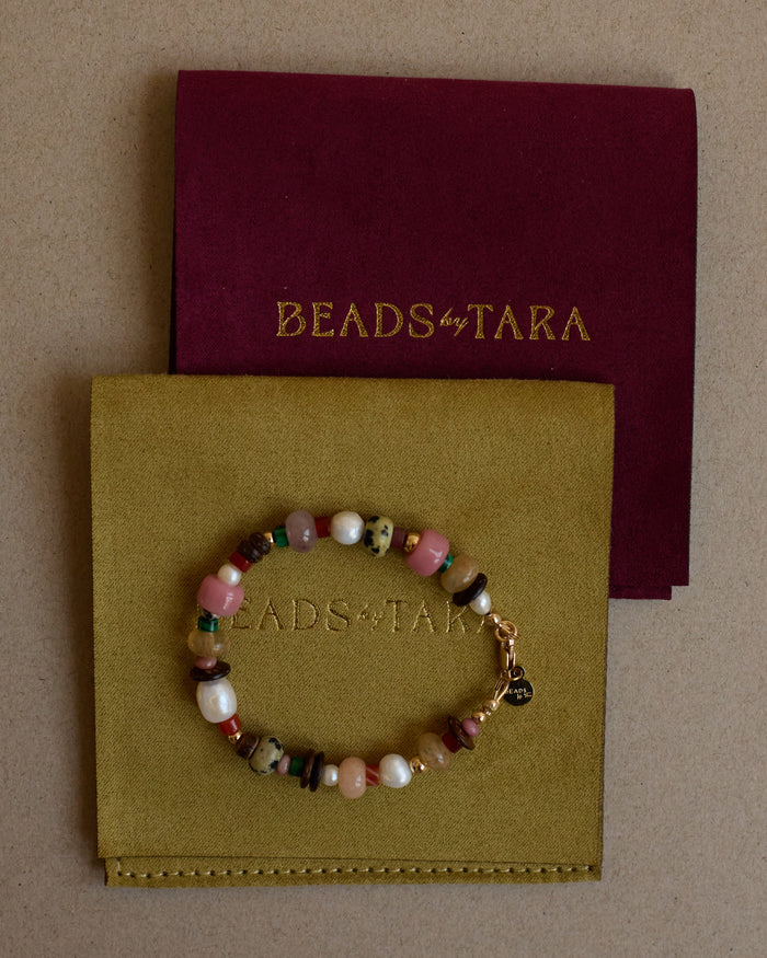 Beaded bracelet on a 'Beads by Tara' card with a maroon backing