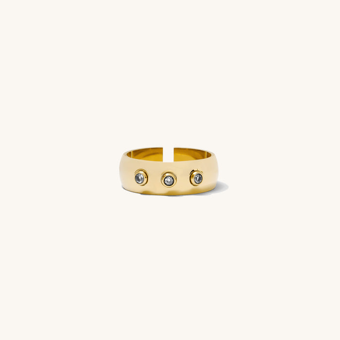 Close up of the gold Anna bezel ring set with three stones on a white background