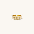 Close up of the gold Anna bezel ring set with three stones on a white background