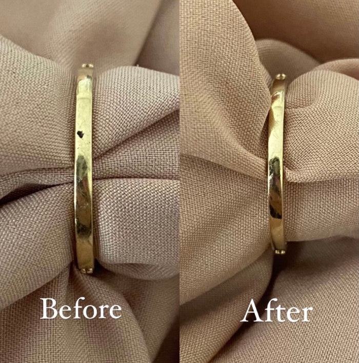 Close up of a hand polishing a gold chain with the anti-tarnish cloth