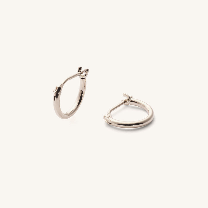Close up of silver hoop earrings on a white background
