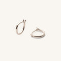 Close up of silver hoop earrings on a white background