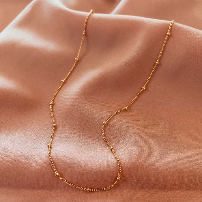 Close up of a neckline wearing the Azin bead accent necklace