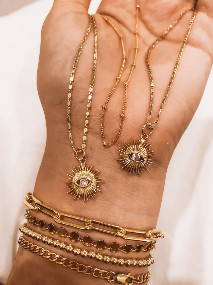 Close up of a neckline wearing the gold Azin cable chain necklace