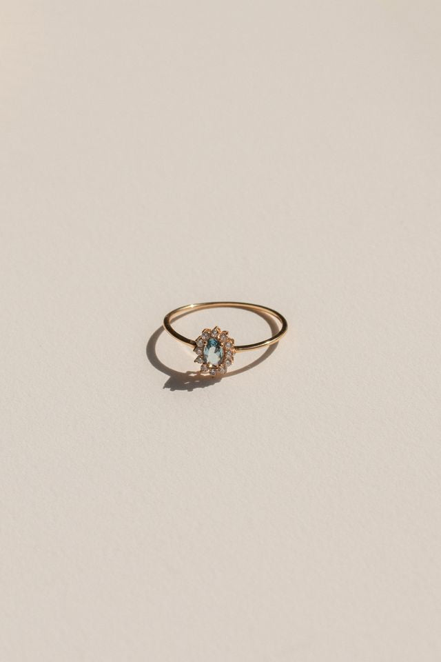 Close view of the Azul ring's halo of crystals around its blue center stone