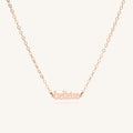 Close up of the gold Believe mini affirmation necklace on a white background