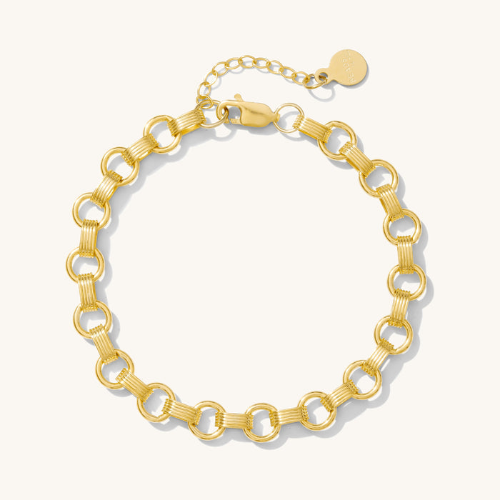 Close up of gold bracelet on a white background