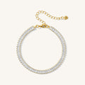 Close up of a gold baguette tennis bracelet on a white background