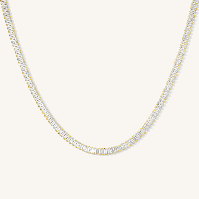 Close up of the gold Bellini tennis necklace on a white background