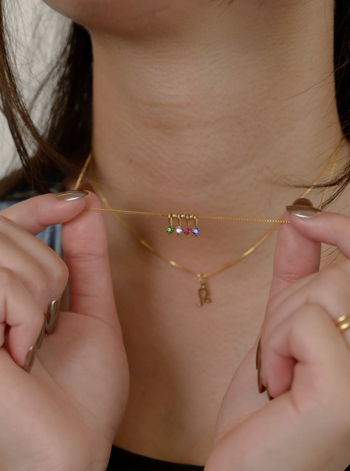 Close up of the gold Birthstone Bead necklace on a white background