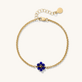 Close up of gold bracelets with colored birthstones