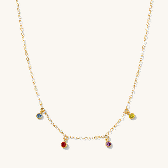 Close up of the gold Birthstone Drop necklace on a white background