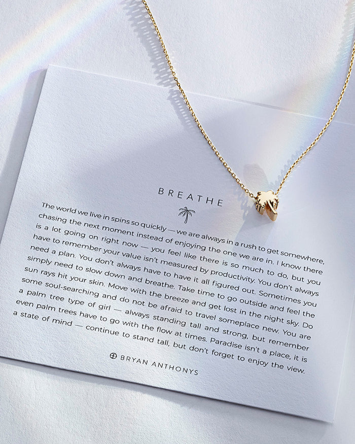 Breathe Necklace showcase in 14k gold on card