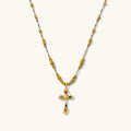 Caliente necklace with a jewel-toned cross pendant encrusted with tiny crystals