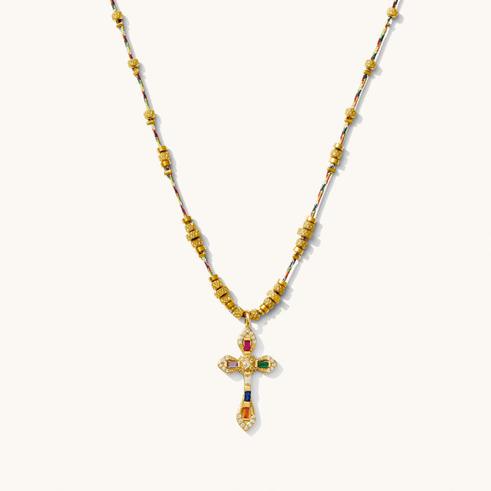 Caliente necklace with a jewel-toned cross pendant encrusted with tiny crystals
