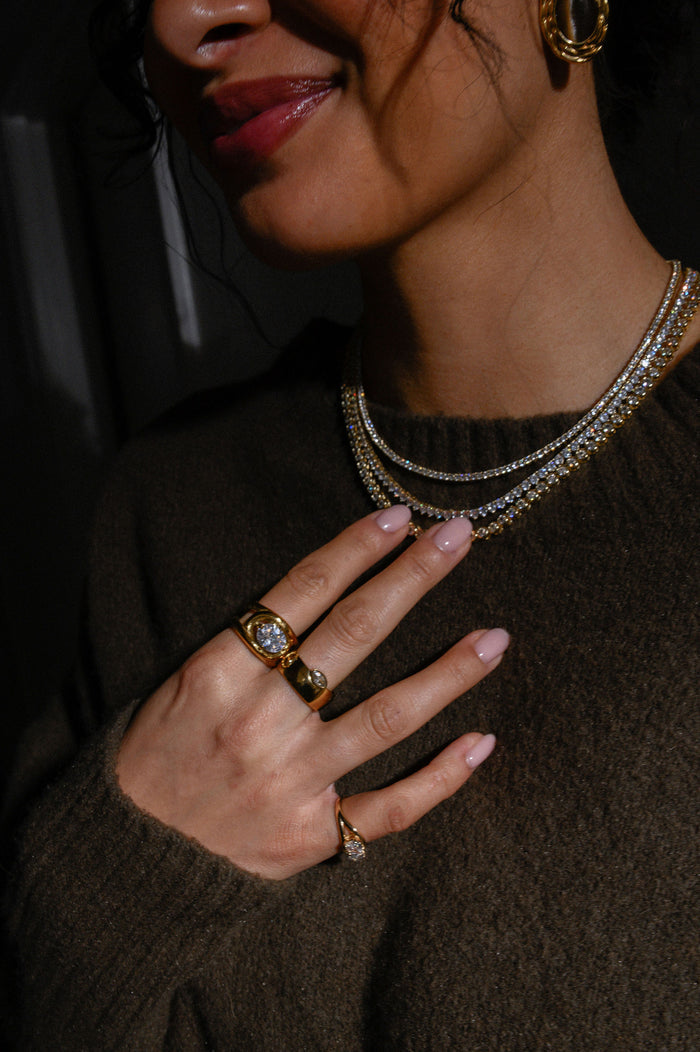 Sparkling gold tennis necklace with a continuous line of prong-set stones