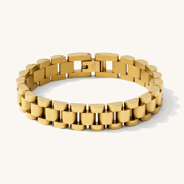 Close up of a gold and silver watch link bracelet on a white background