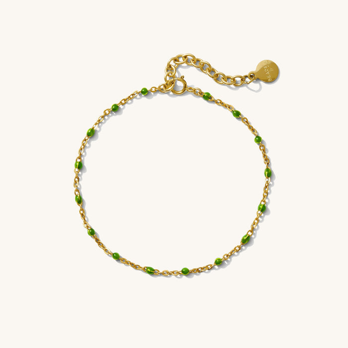 Close up of a chain bracelet with black beads on a white background