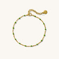 Close up of a chain bracelet with black beads on a white background