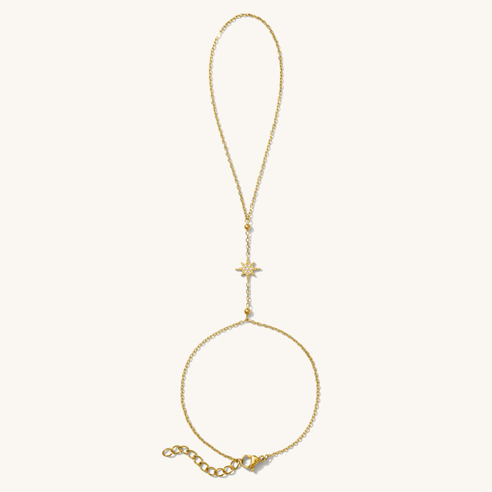 Celeste hand chain in 14k gold fill with a sparkling white topaz star charm