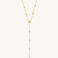 Close up of the gold Celeste lariat necklace on a white background