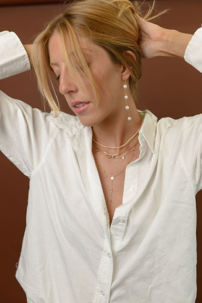 Studio close up of the gold Celeste lariat necklace on a white background
