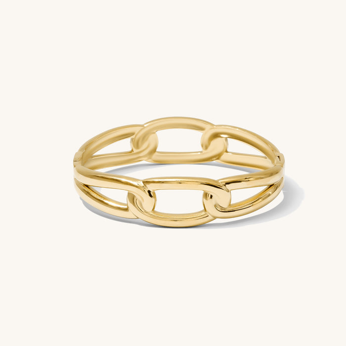 Close up of gold cuff bracelet on a white background