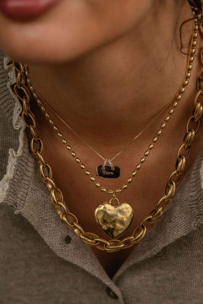 The Cherie heart pendant necklace in antiqued gold with a vintage-inspired finish
