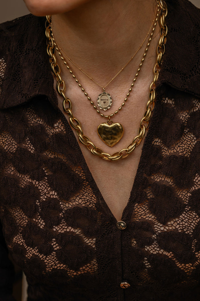 Antiqued gold Cherie necklace with an imperfectly sculpted heart charm