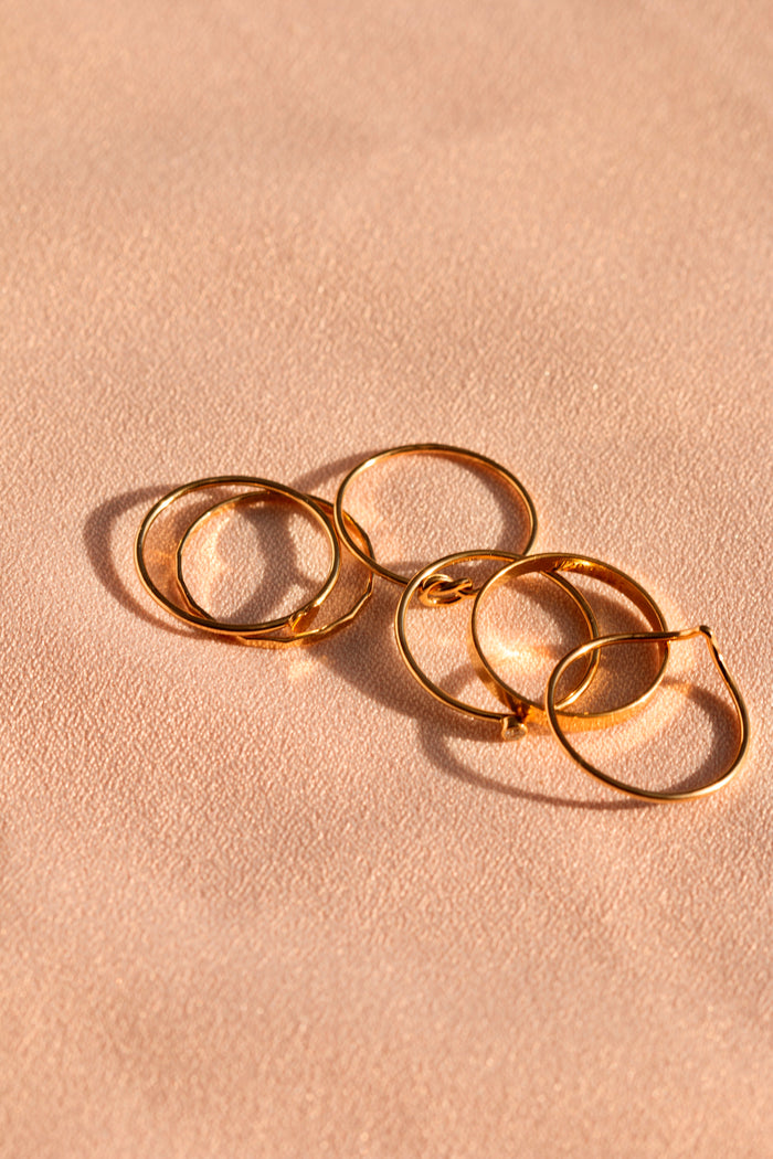 Gold-filled Chevy ring styled on the hand with dainty stacking rings